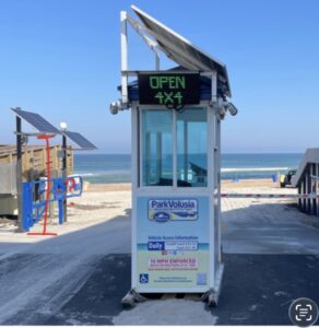 Solar-powered LED sign showing OPEN at a Daytona Beach ParkVolusia beach ramp toll booth