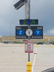 Solar-powered LED parking count sign at Denver International Airport running a scrolling test message