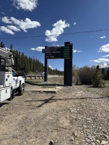 Overhead gantry-mounted LED parking availability sign at a Breckenridge town entrance