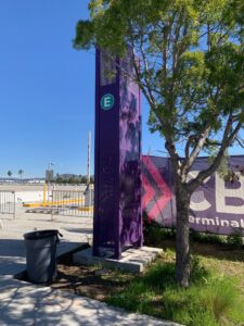 LED parking pylon sign in a purple enclosure at the Cross Border Xpress Terminal E entrance