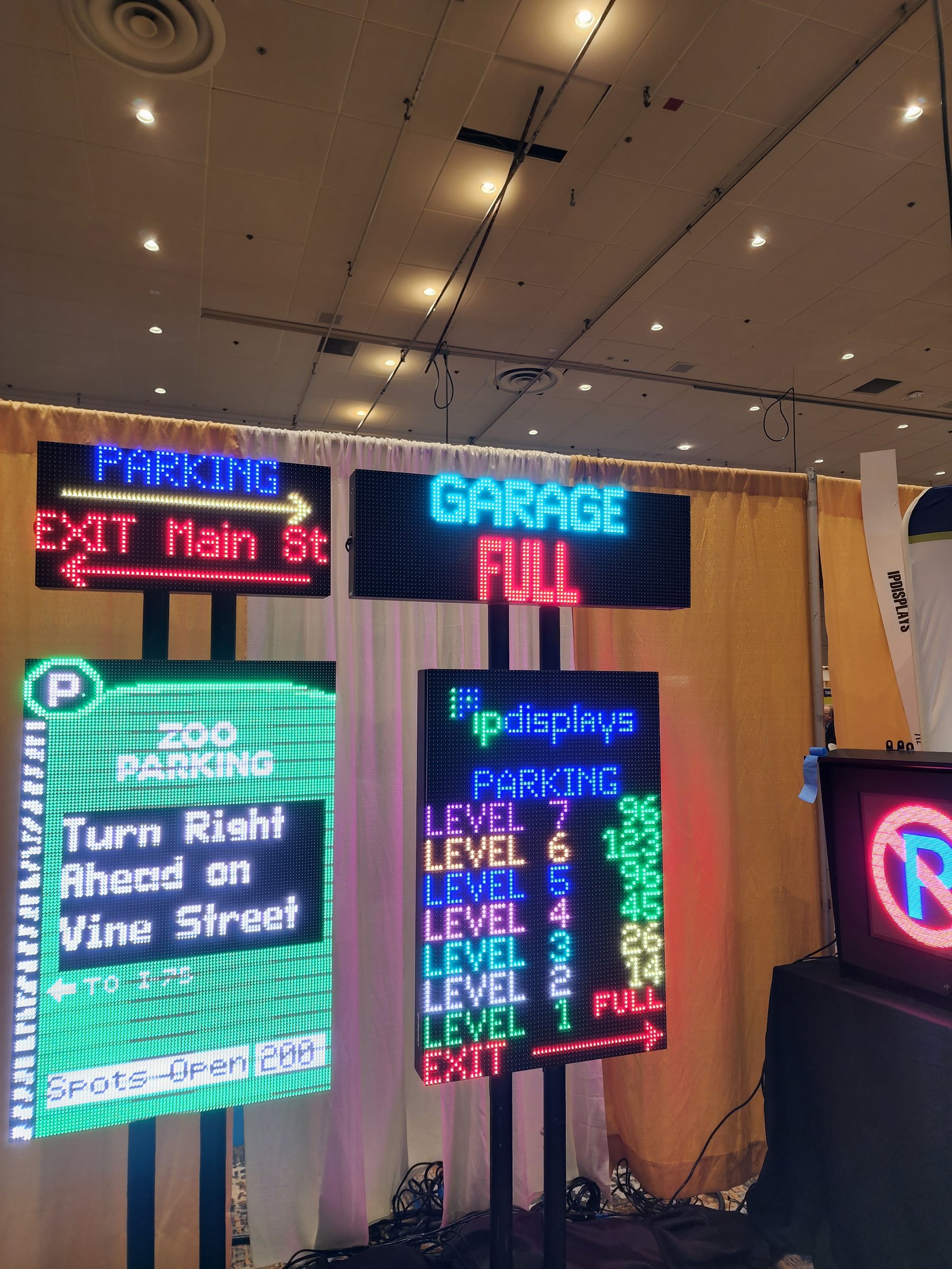 The IPdisplays tradeshow booth showing a lineup of parking guidance LED signs