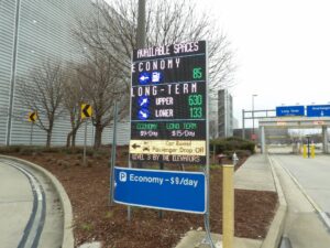 Full-colour LED sign at Memphis International Airport showing available spaces for economy and long-term parking alongside the daily rates