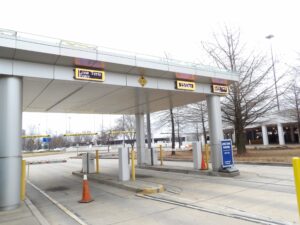 Amber LED lane signs under the long-term parking entry canopy at Memphis International Airport showing entry lanes and the daily rate
