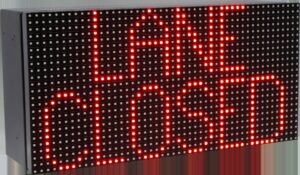 Product shot of a red LED sign displaying LANE CLOSED