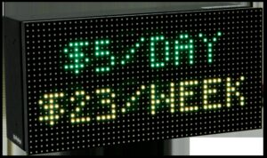 Product shot of an LED sign displaying daily and weekly parking rates